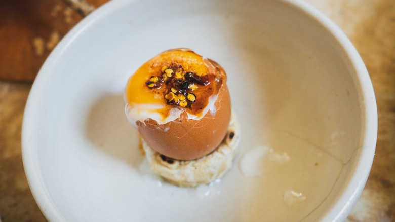 A plated and seasoned soft-boiled egg