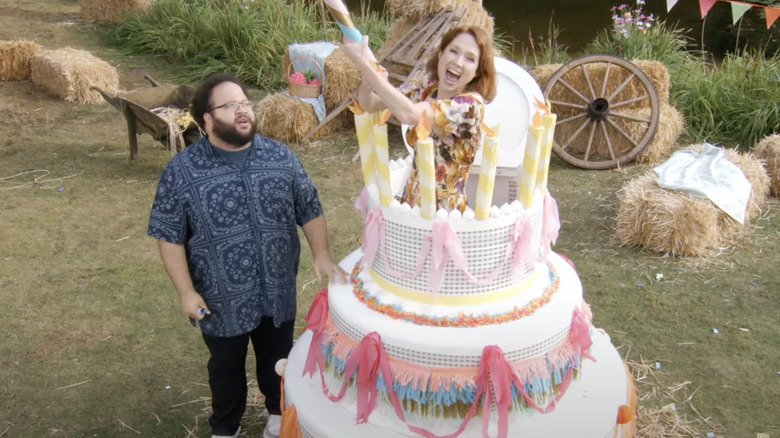 Zach Cherry and Ellie Kemper with giant cake