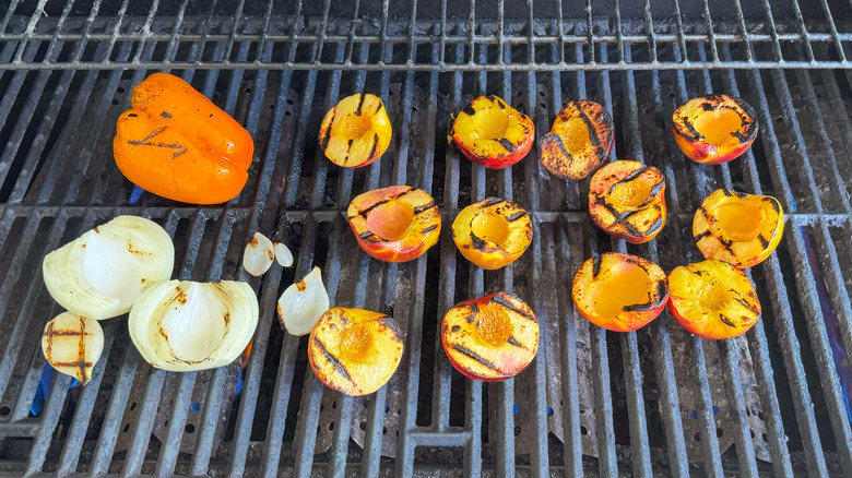 Charred bell pepper, onion, and peaches on grill grates