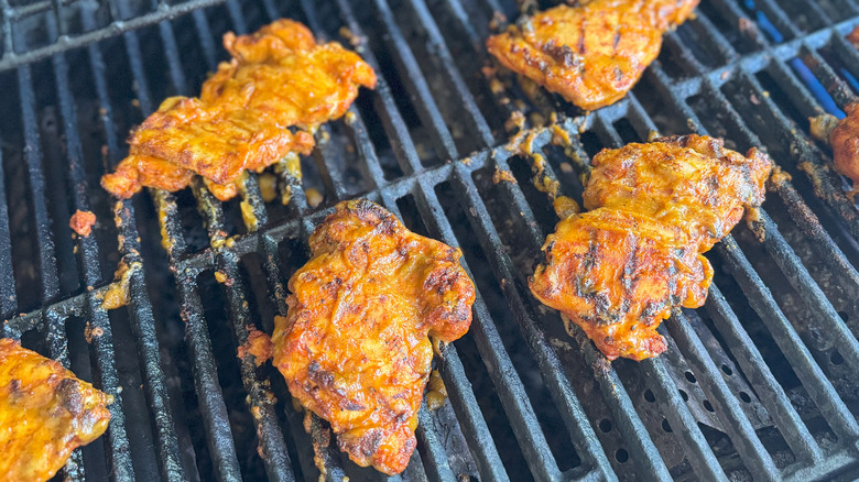 Peach bbq chicken thighs on grill