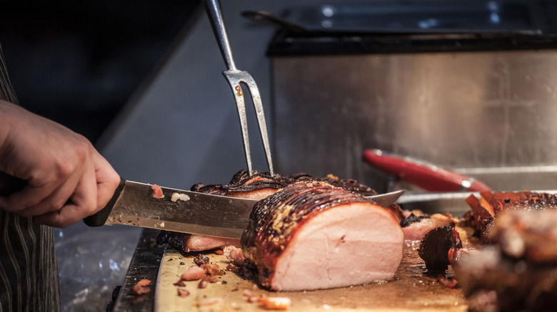 chef slicing grilled peameal bacon