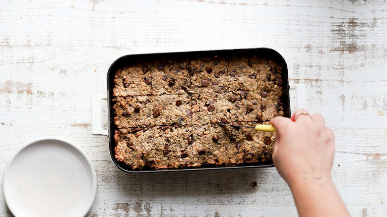 Cutting baked tray of oatmeal