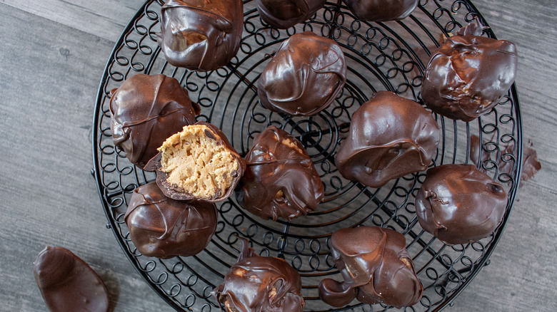 Chocolate peanut butter balls cool on a rack