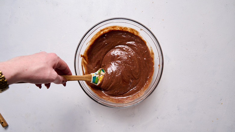 stirring chocolate into pudding