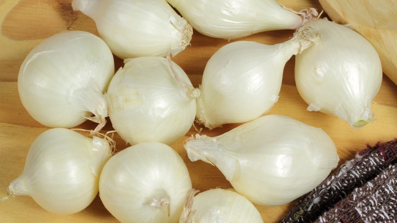 Close-up of several raw pearl onions