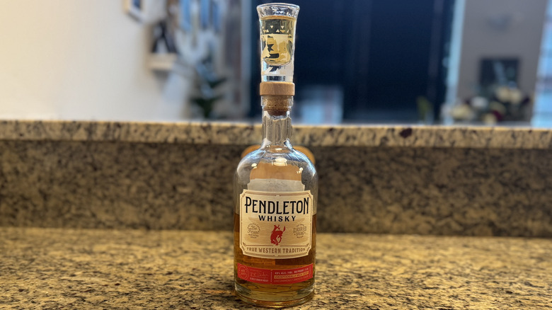 Pendleton Whisky bottle on counter with shot glass on top