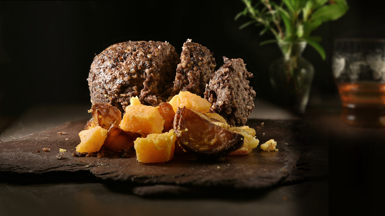 haggis on stone board in dark room