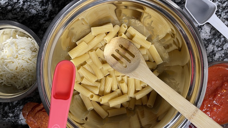 cooked rigatoni with slotted spoon