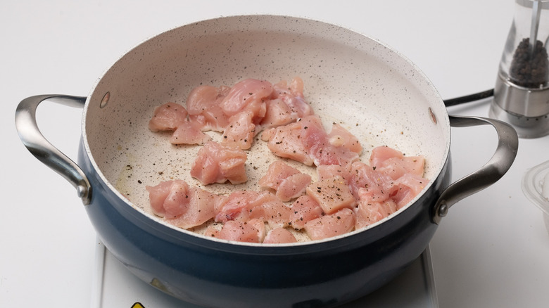 chicken frying in pan