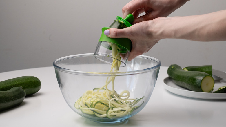 spiralizing zucchini into a bowl