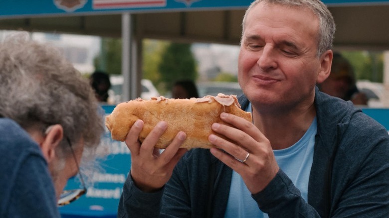 Phil Rosenthal trying a sandwich