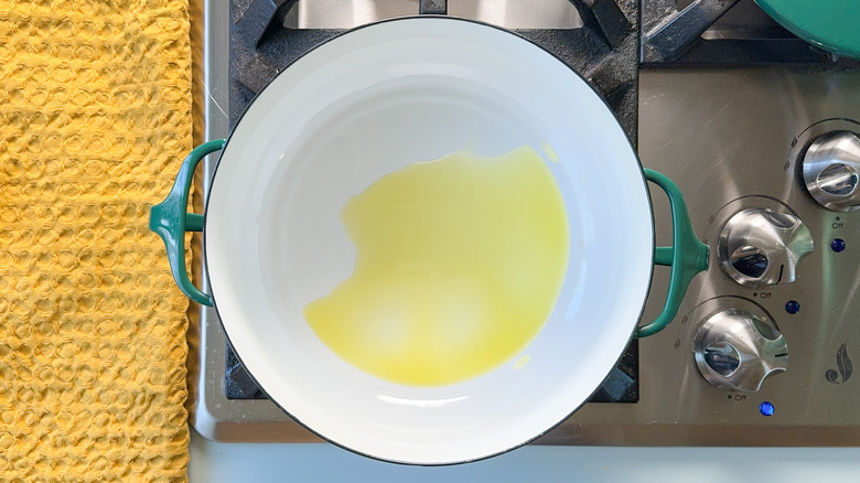 Olive oil heating in pot on stove top