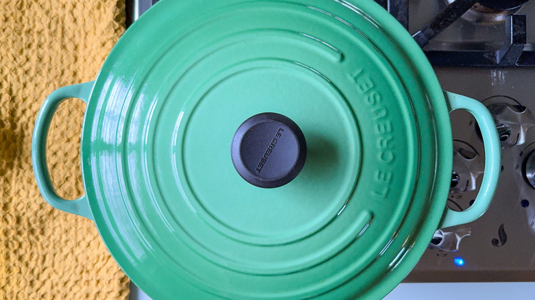 Large green covered pot on stovetop