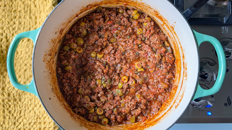 Cuban picadillo simmering in pot on stove top