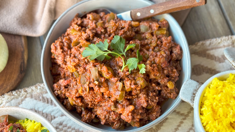 Cuban picadillo in serving bowl with parsley garnish