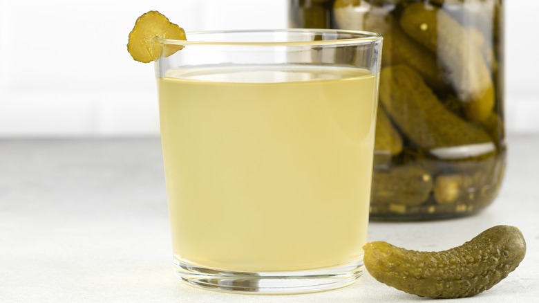 Glass and jar of pickle juice