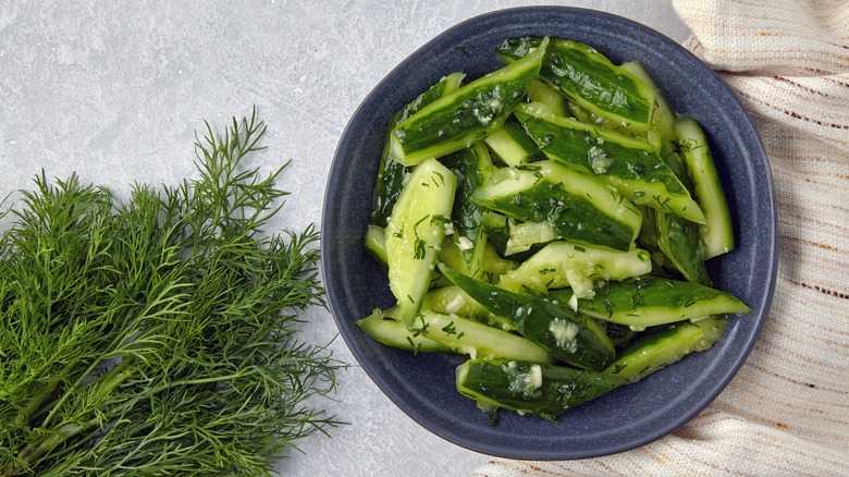 Bowl of smashed cucumbers and herbs