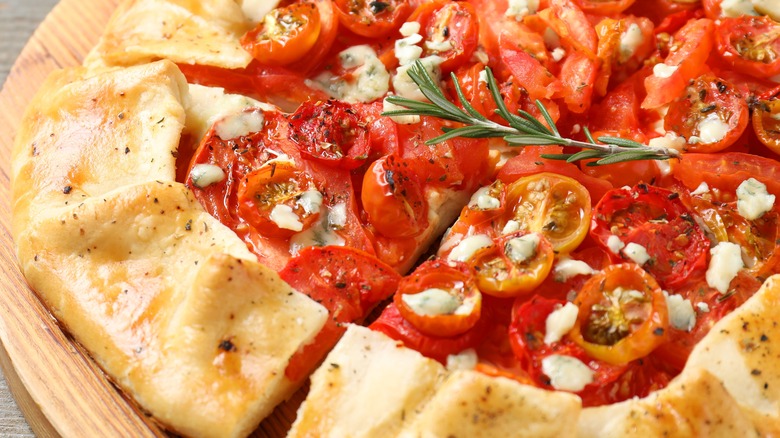 tomato and cheese galette on wooden table