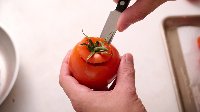 carving the tops off of the tomato