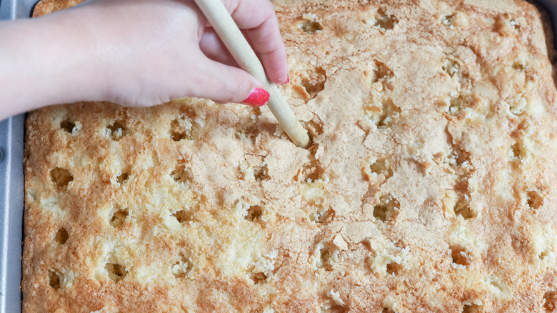 poking holes in pineapple cake