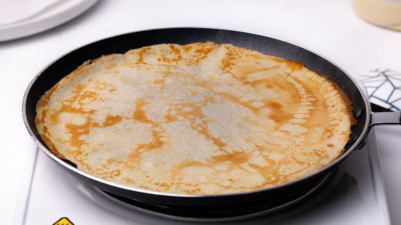 Crepe cooking in frying pan 