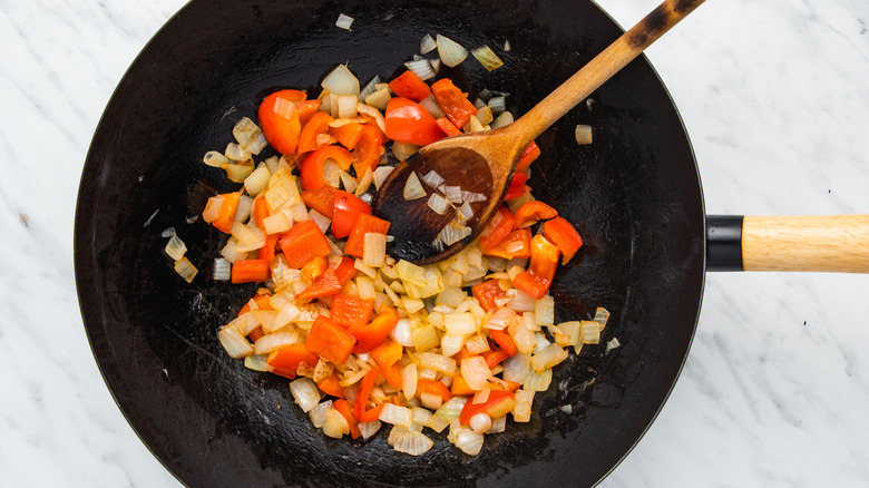 onion and pepper in wok 