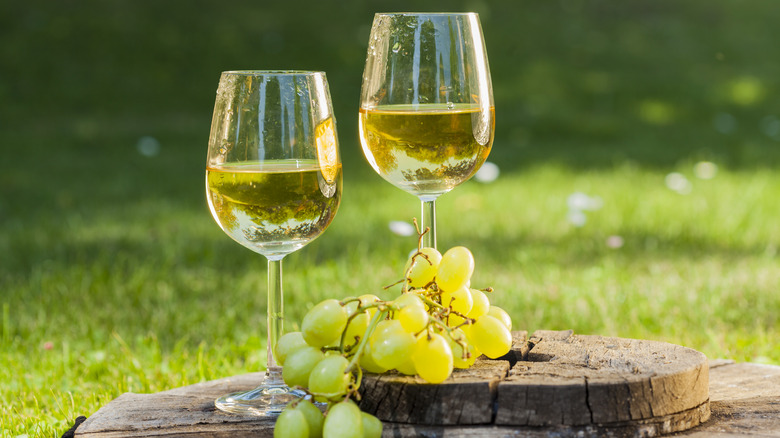 White wine glasses with grapes