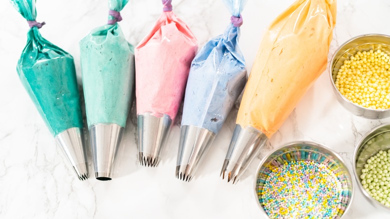 piping bags full of differently colored frostings
