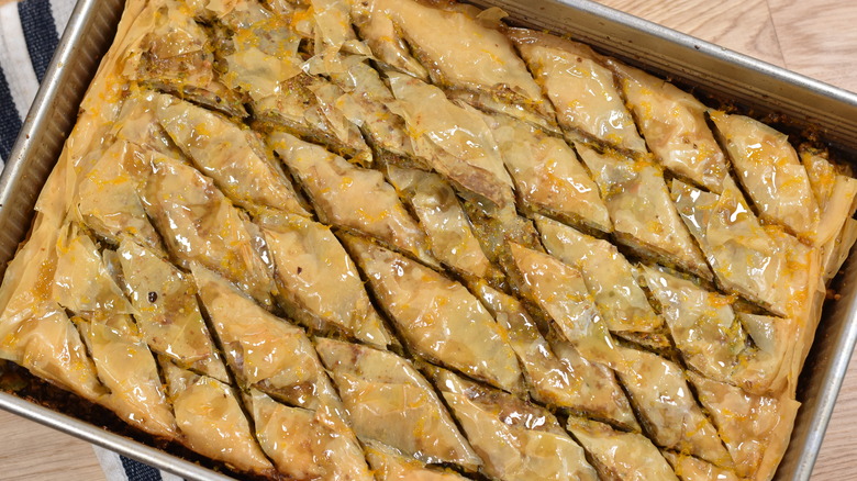 pouring simple syrup on baklava