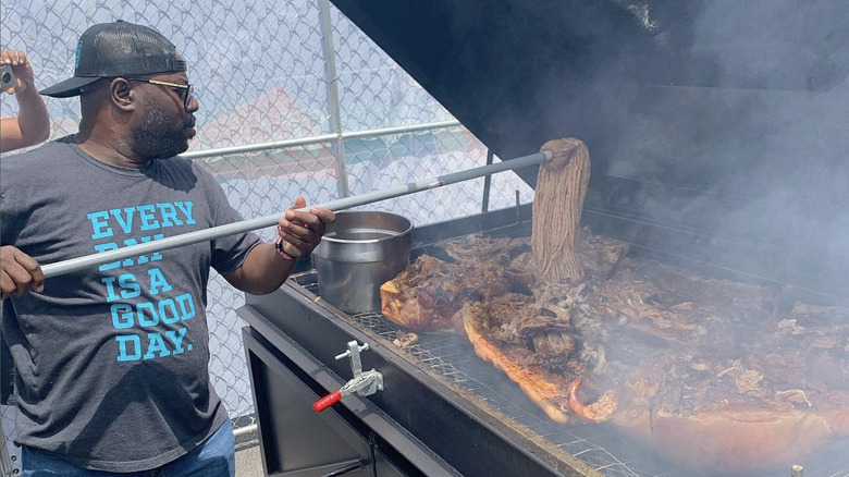 Rodney Scott mopping a pig