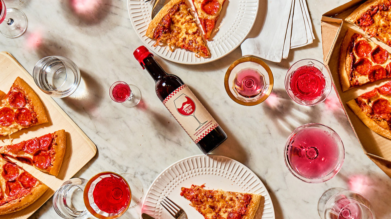 Pizza Hut Tomato Wine surrounded by pizza