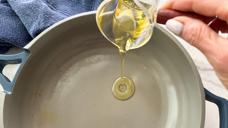 adding oil to a pan