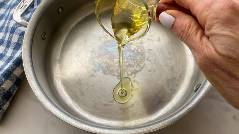 adding oil to pan