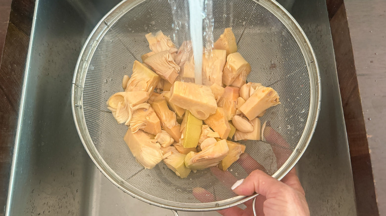 colander with jackfruit being rinsed