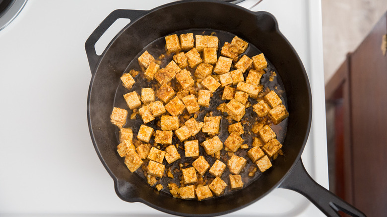 marinated tofu cubes in pan 