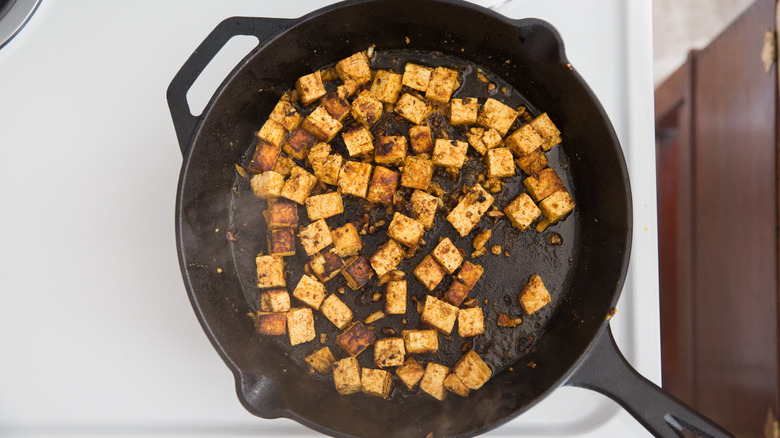 marinated tofu cooking in pan 