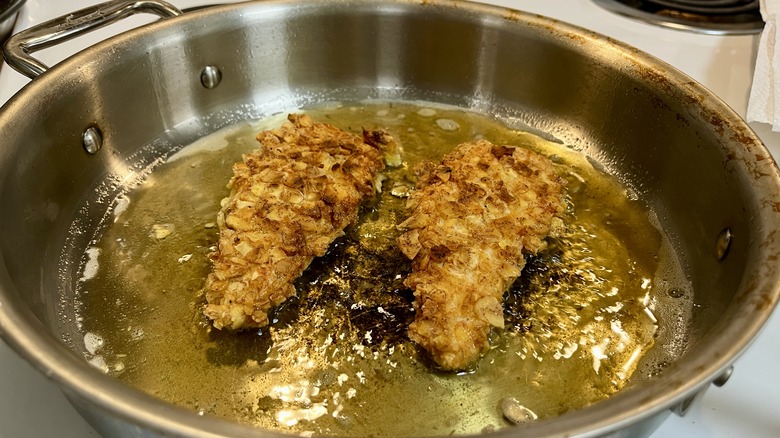 chicken fingers frying in oil