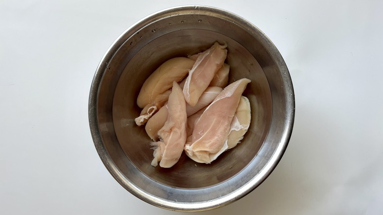 raw chicken in metal bowl