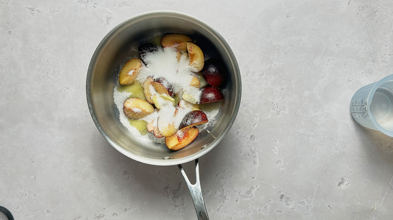 plum and sugar in saucepan