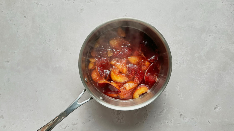 cooked plums in saucepan