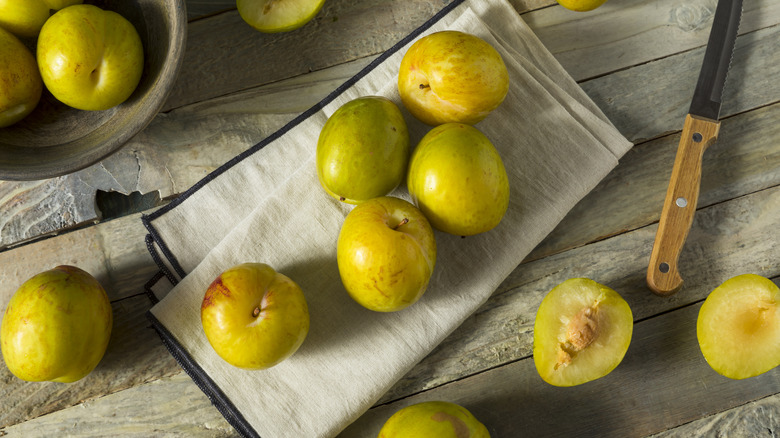 green pluots on wood