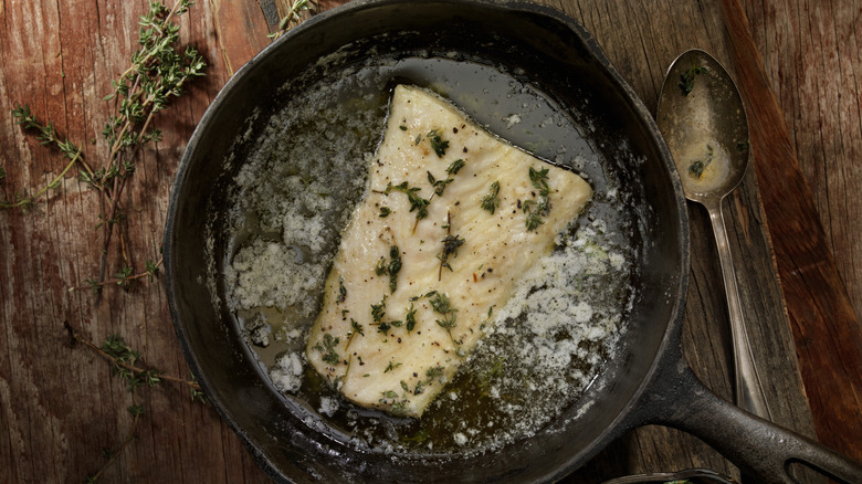 halibut in skillet poached in herb butter