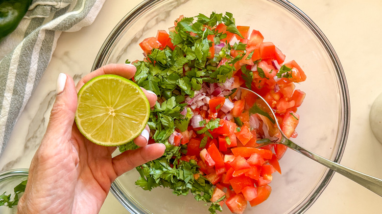 hand adding lime to bowl