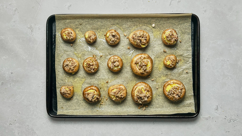 sausage stuffed mushrooms on baking sheet