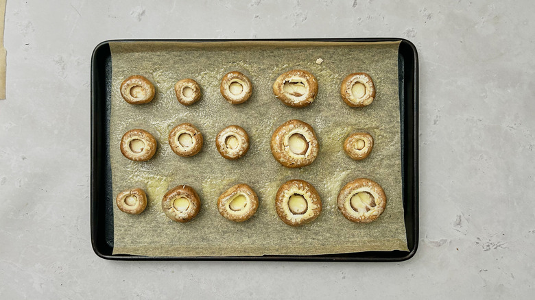 oiled mushrooms on baking sheet