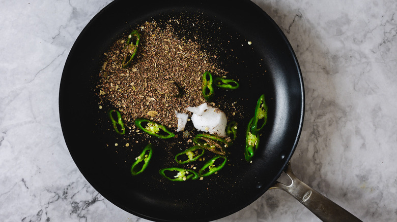 Pan with coconut oil, chilies and spices