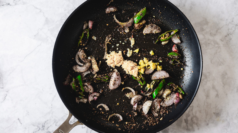 Pan with shallots, chilies and spices with ginger and garlic