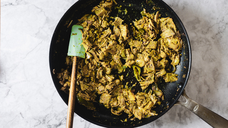 Pan of jackfruit curry with spatula