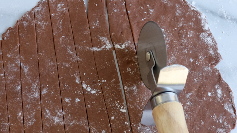 slicing cocoa dough into strips