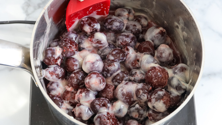 milky cherries and juice in pot